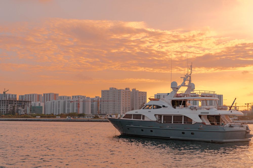 Yacht sailing into a golden sunset offshore