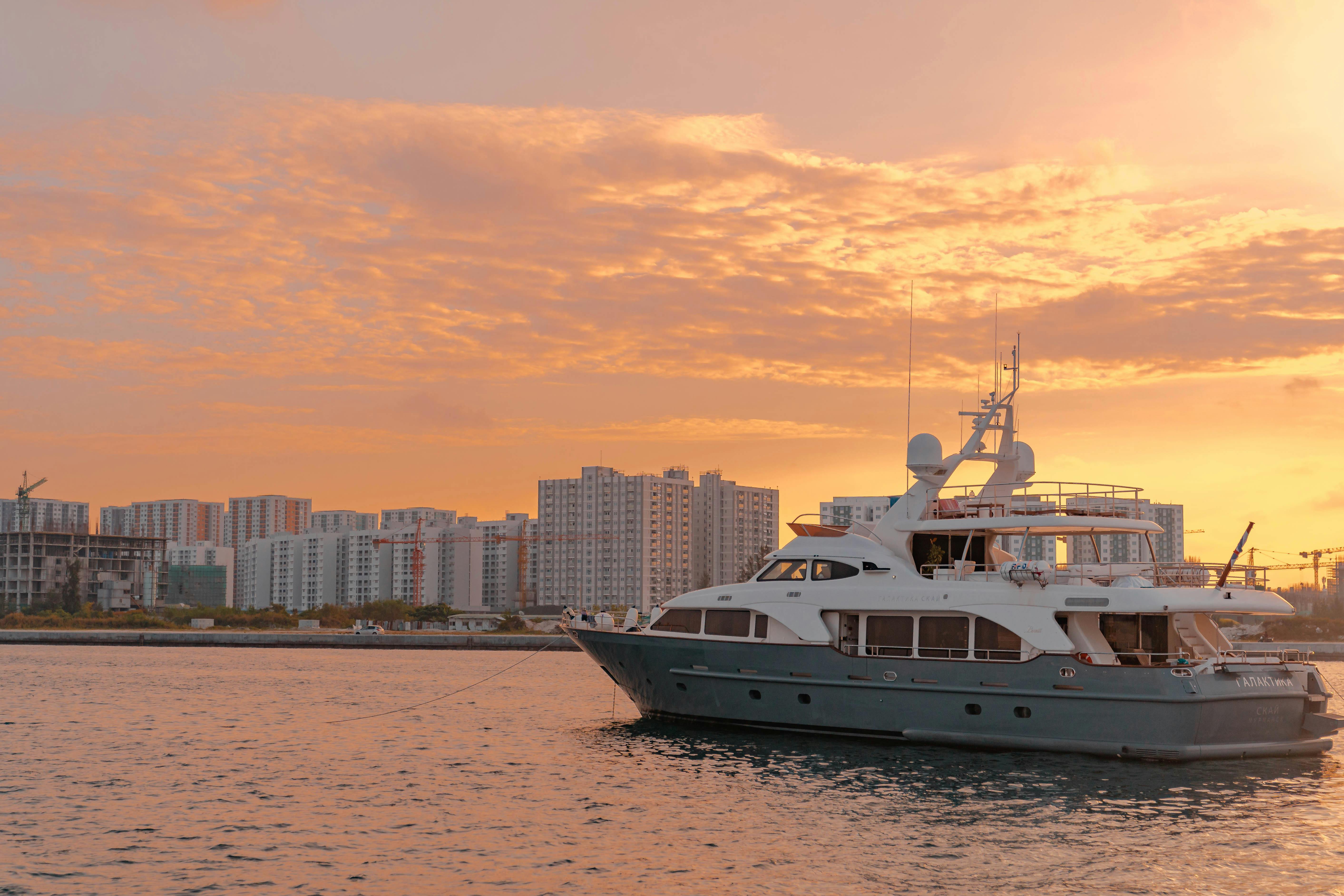 Luxury Yacht Sailing at Sunset · Free Stock Photo