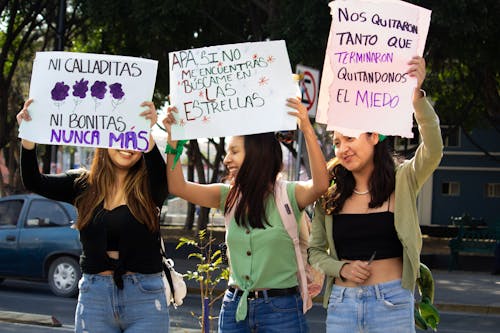 Young Girls Holding Banners at a Protest 