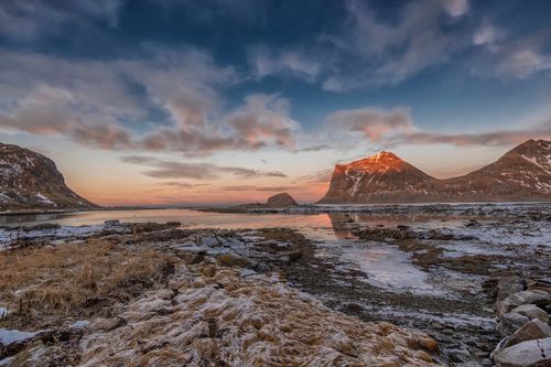 Free Ethereal winter landscape of Lofoten Islands featuring a tranquil coastal view at sunset. Stock Photo