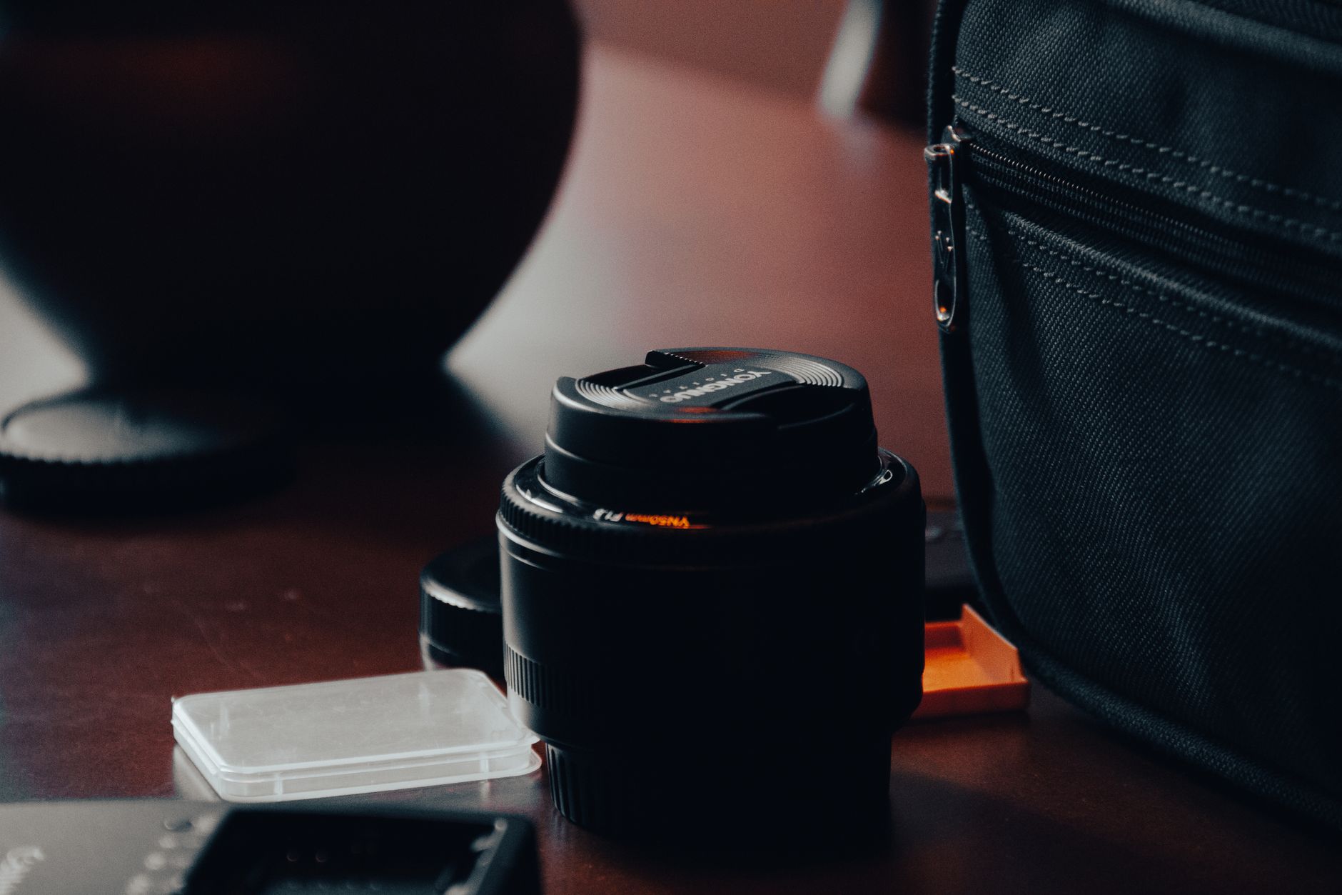 closeup professional camera and lens on a dark photography desk
