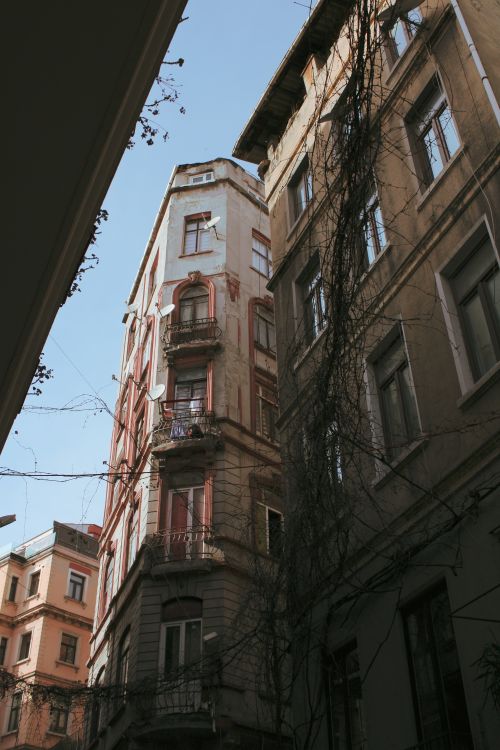 Free Low angle view of historic tenement buildings under a clear blue sky, showcasing classic architecture. Stock Photo