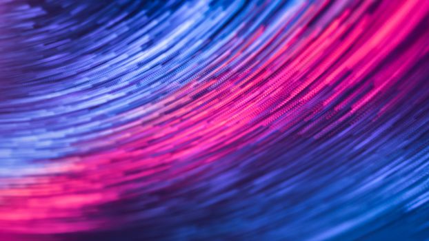 A dynamic abstract image featuring swirling pink and blue lights in motion, creating a futuristic feel.