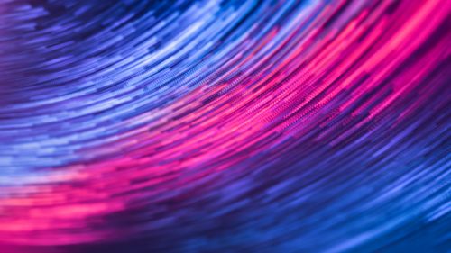 Free A dynamic abstract image featuring swirling pink and blue lights in motion, creating a futuristic feel. Stock Photo