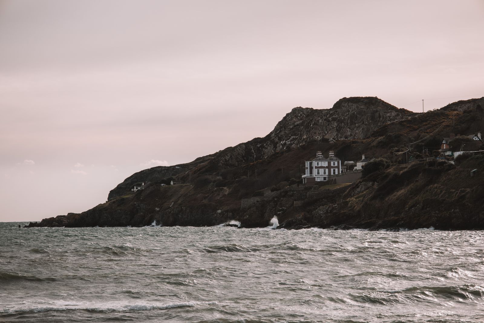 A view of Howth Head's rugged coast in Dublin, Ireland, with a ocean backdrop