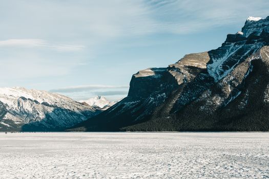 Snow-covered mountains and frozen lake in Banff National Park, Alberta, Canada.