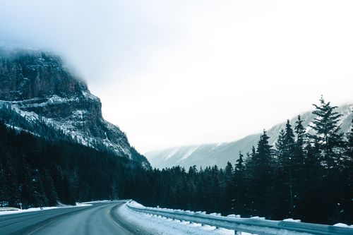 Free Experience the serene beauty of a snowy mountain road in Revelstoke, BC. Stock Photo
