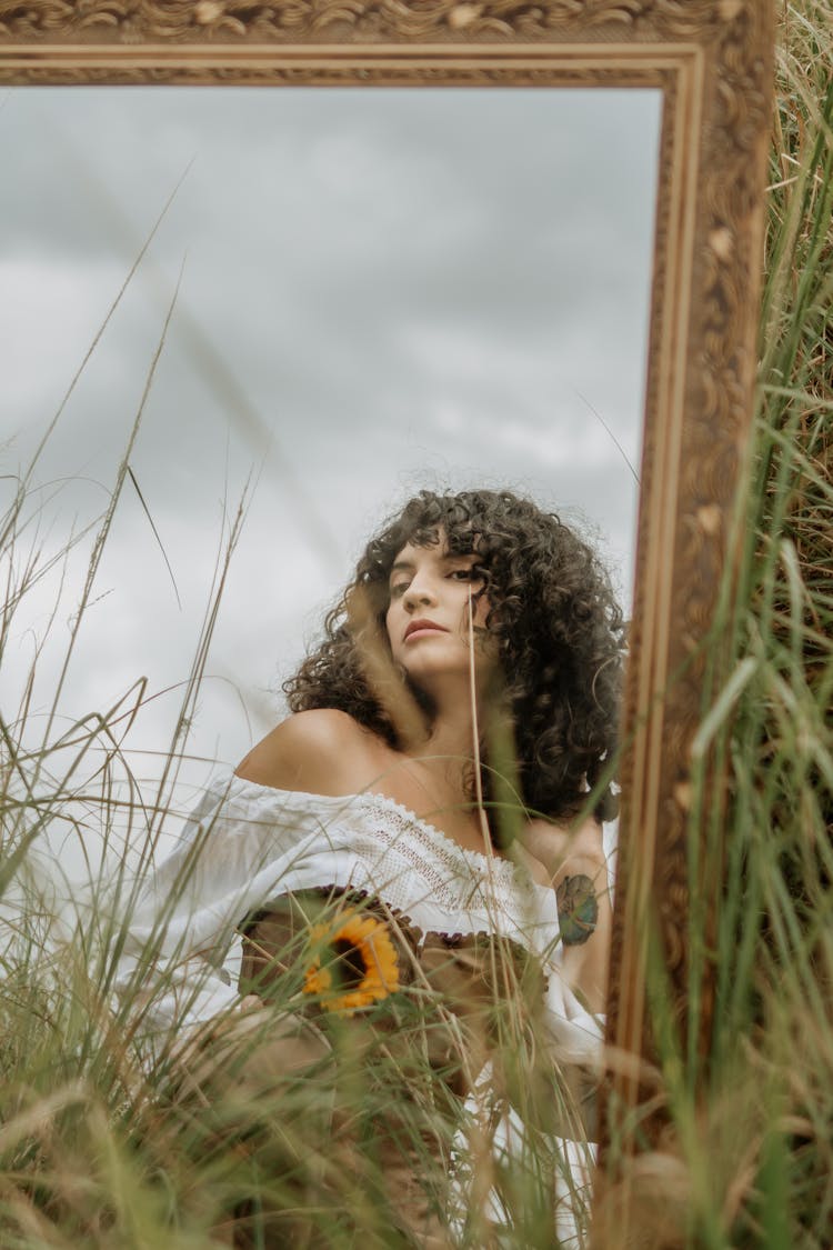 Woman Reflecting In A Mirror