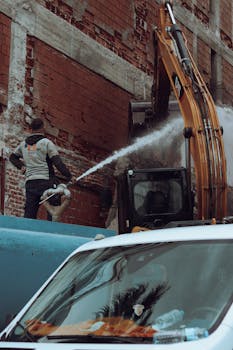 Construction worker operates excavator on building site in İzmir, Türkiye.