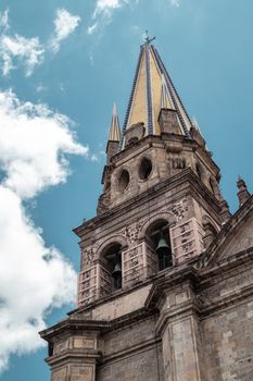 Stunning vertical shot of the Guadalajara Cathedral spire against a clear blue sky.