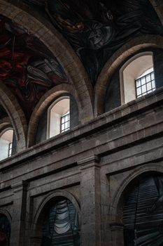 Interior view of the iconic arches and murals at Hospicio Cabañas, a UNESCO World Heritage Site in Guadalajara, Mexico.