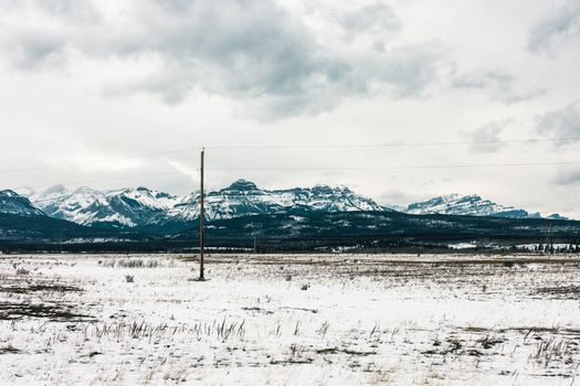 Breathtaking winter view of the snowy mountains and plains in Kananaskis, Alberta.