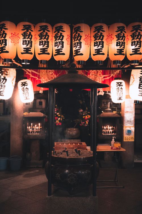 Free Beautifully illuminated Shinto shrine with traditional lanterns glowing in the night, creating a serene spiritual atmosphere. Stock Photo