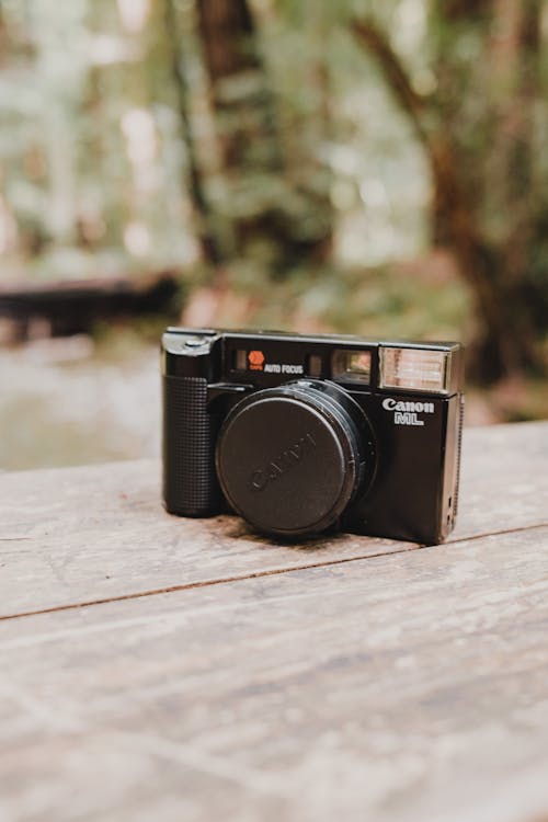 Close-up of a Film Camera Standing on a Wooden Table 