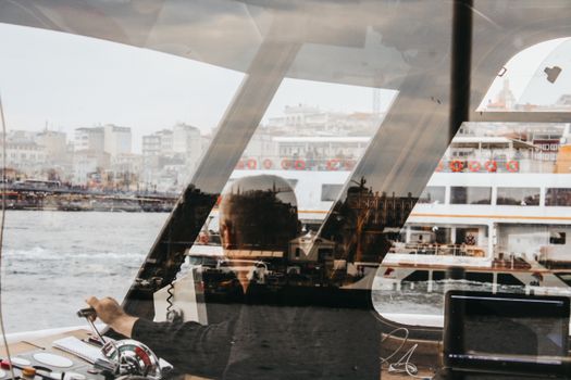 A Helmsman Steering a Passenger Ship in the Bosphorus Strait 