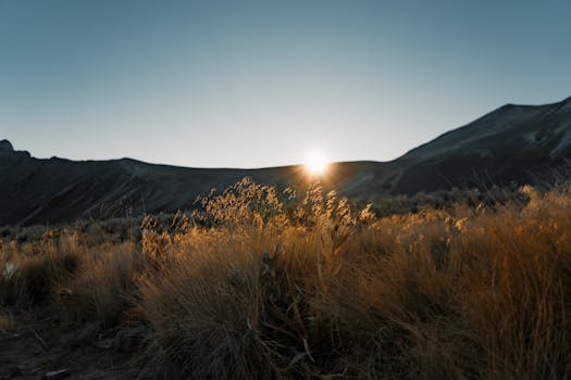 A breathtaking view of sunrise over grasslands and hills in Toluca, Mexico.