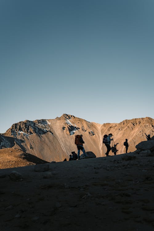 People Hiking in Mountains