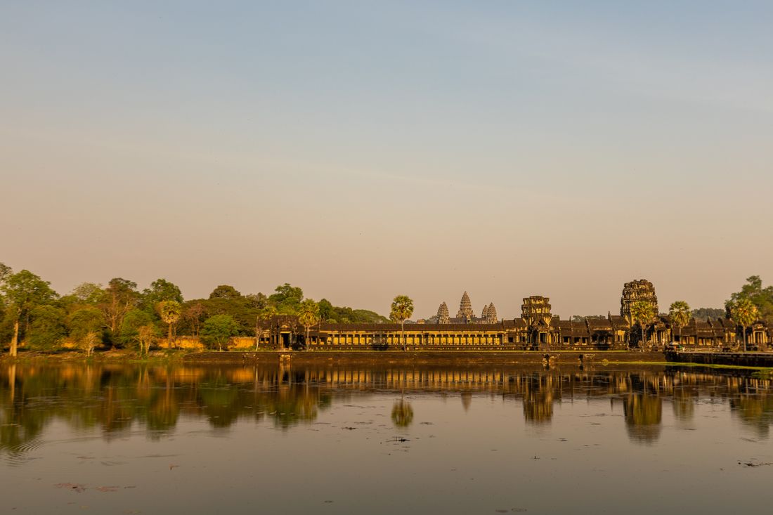 Angkor Wat reflected in water at sunrise