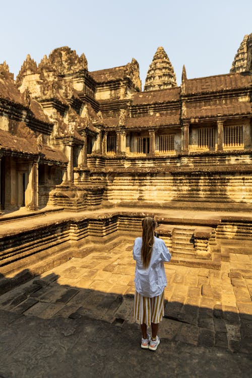 Woman Standing in the Courtyard of the Angkor Wat, Siem Reap, Cambodia