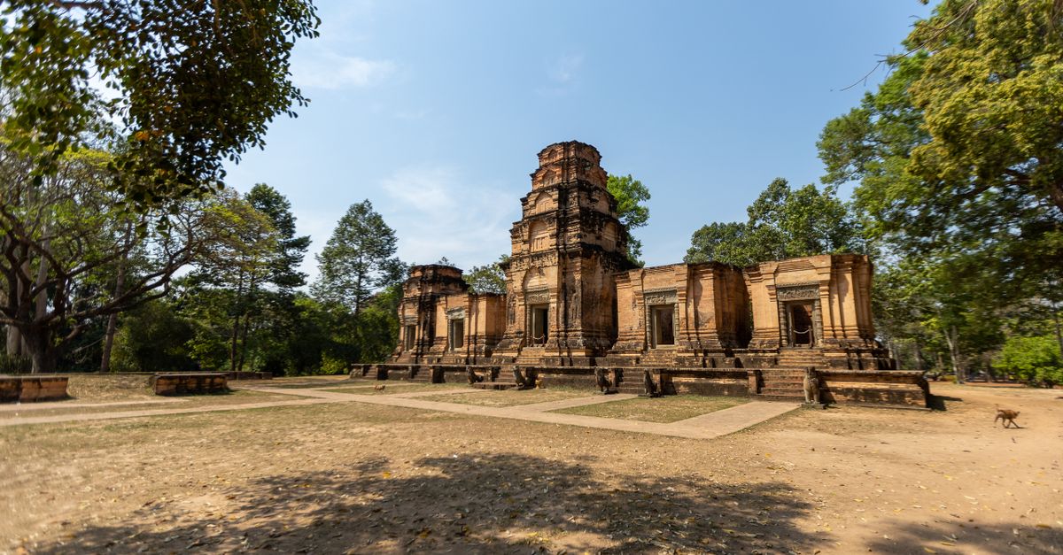 Explore the ancient ruins of a temple in Siem Reap, Cambodia under a clear blue sky.