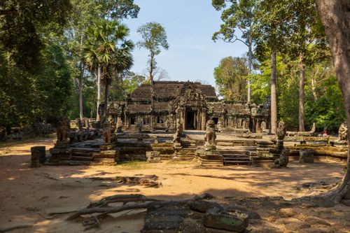 Free Explore the historic Angkor Wat temple nestled in Cambodia's lush forest, a masterpiece of ancient architecture. Stock Photo