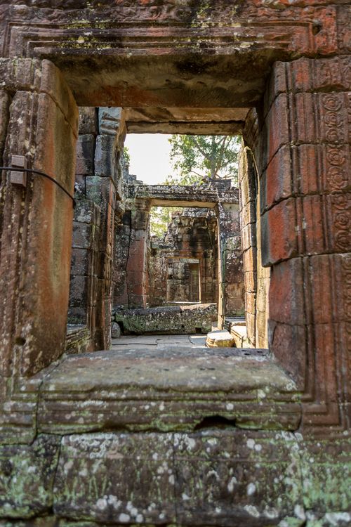 Free A captivating view through ancient temple ruins highlighting Cambodia's rich heritage. Stock Photo