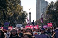 Women's rights demonstration at the Angel of Independence in Mexico City, showcasing activism and solidarity.