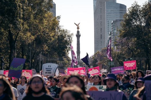 Women's rights demonstration at the Angel of Independence in Mexico City, showcasing activism and solidarity.