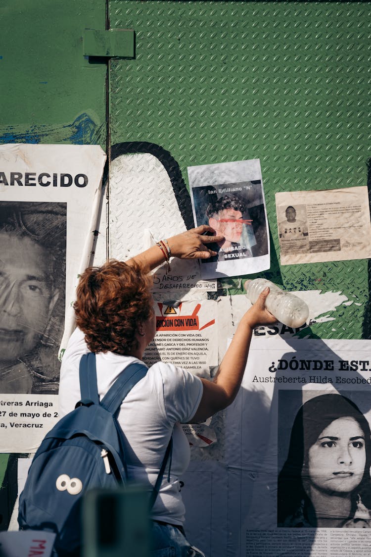 Woman Holding Poster On Wall