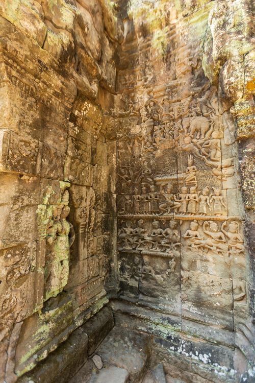 Free Detailed stone carvings inside a temple wall at Angkor Wat, showcasing ancient craftsmanship. Stock Photo