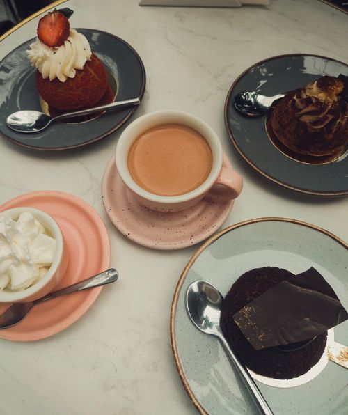 Free High-angle view of coffee and desserts on a table, perfect for a cozy café setting. Stock Photo