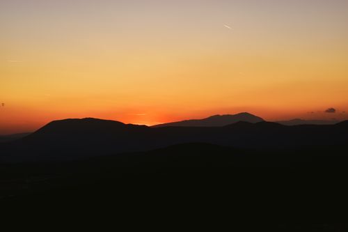 Free A breathtaking sunset casting a warm glow over rolling hills in Bosnia and Herzegovina. Stock Photo