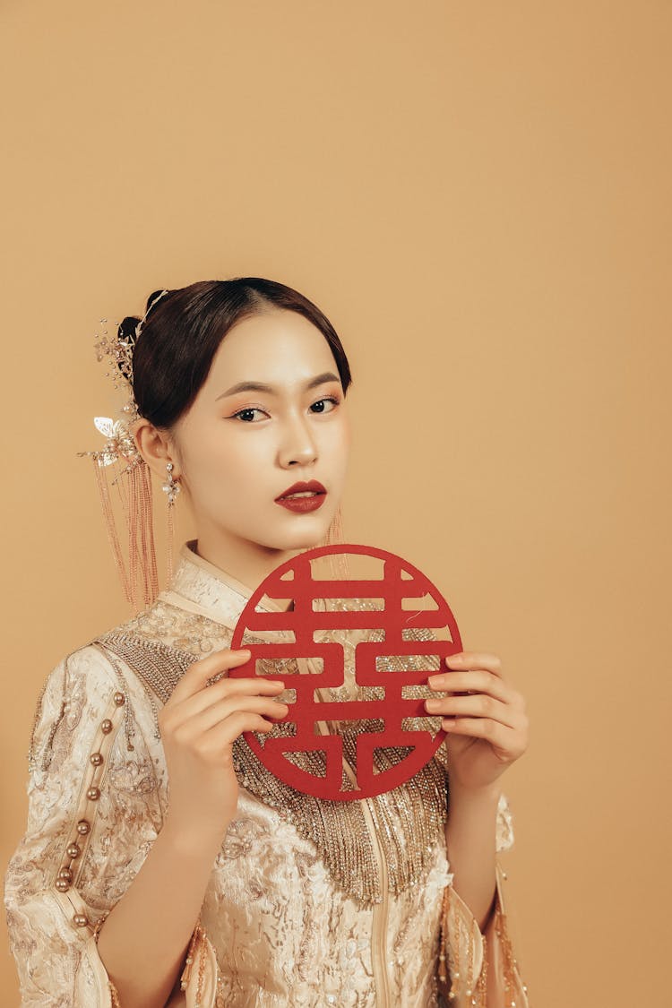 Young Beautiful Woman Holding Decoration With Chinese Signs Of Happiness