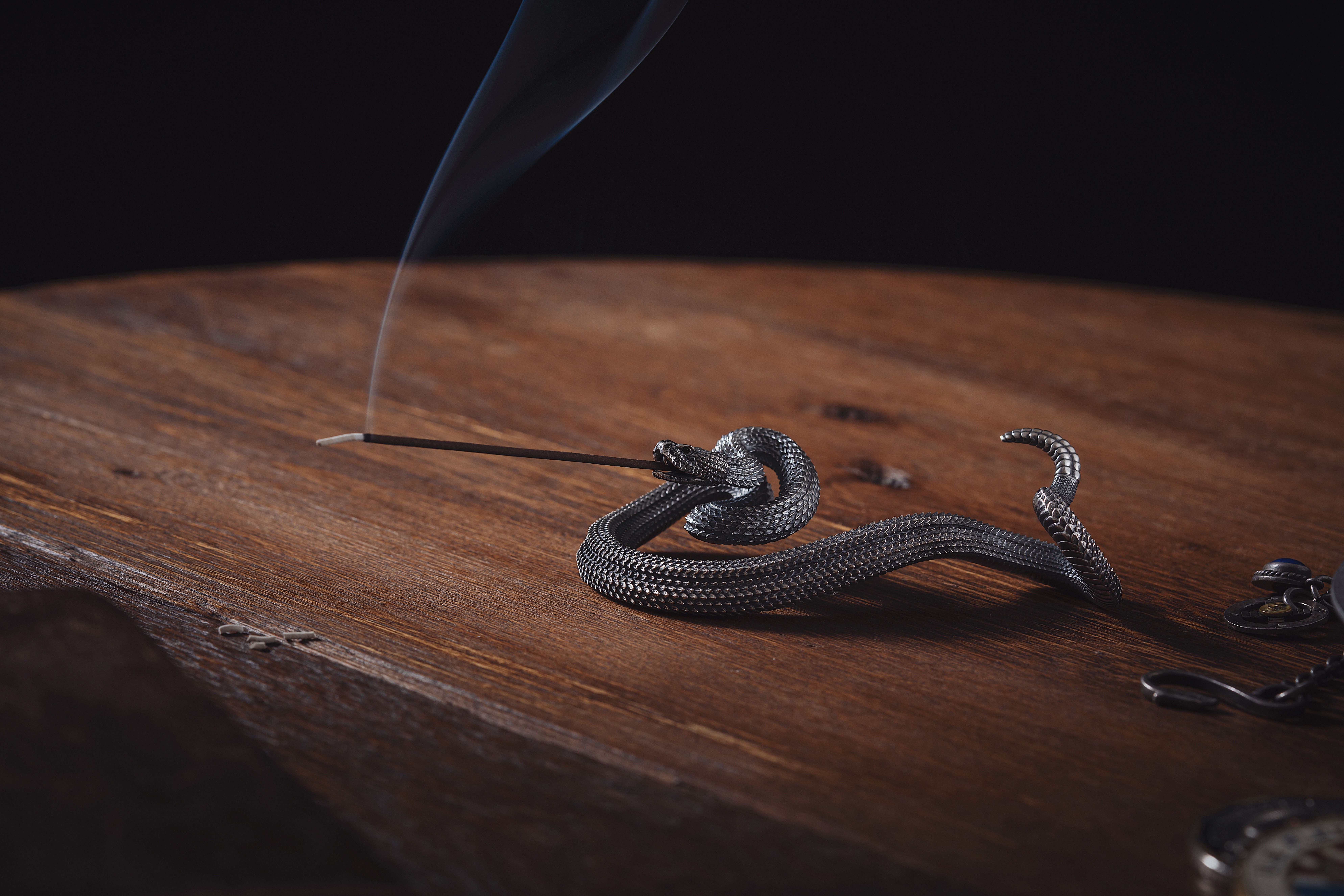 Silver Snake Figurine on a Wooden Desk · Free Stock Photo