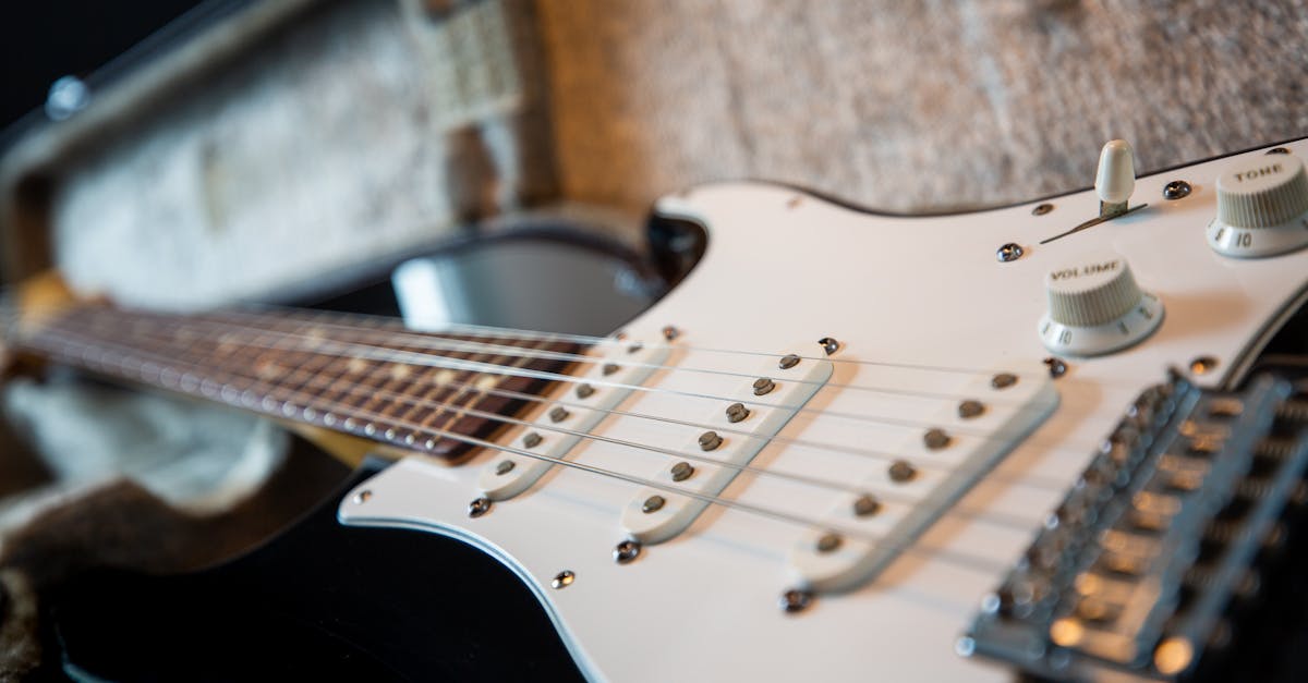 Selective Focus Photography of Black Electric Guitar