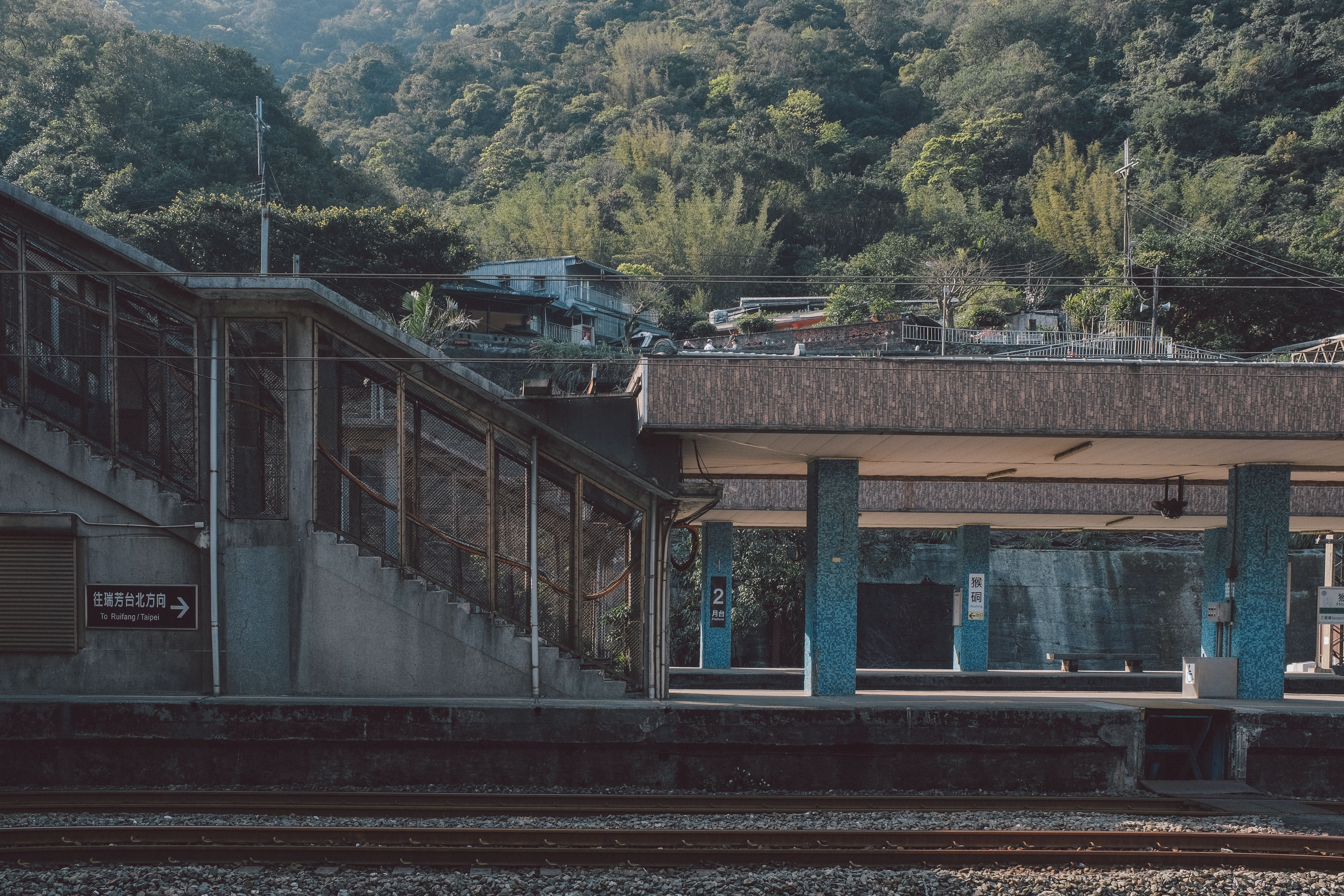 A quiet rural train station that looks like it's from an anime