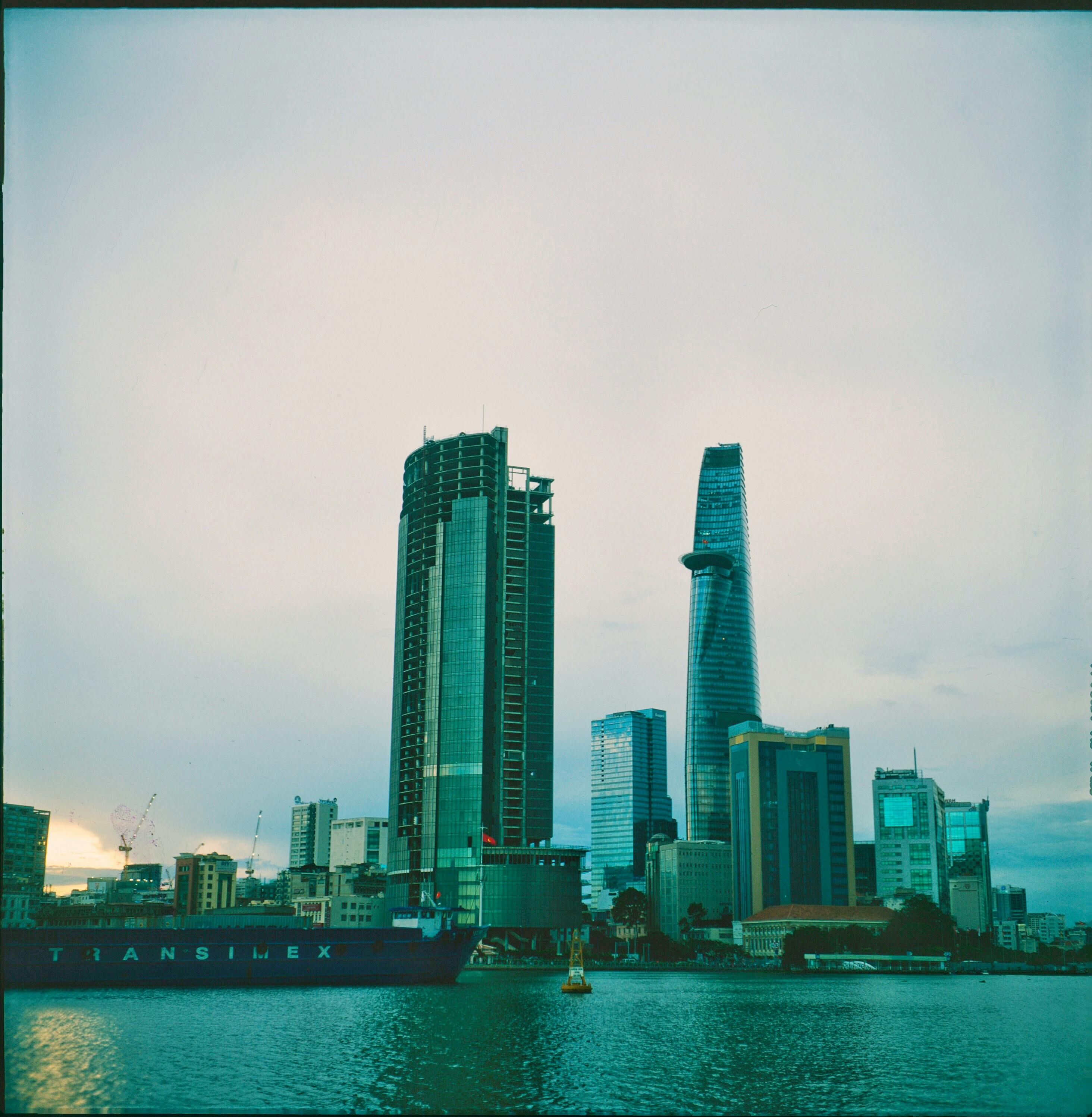A modern urban skyline featuring skyscrapers and a waterfront view, ideal for architectural themes.