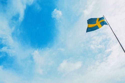 Flag of Sweden under White Clouds