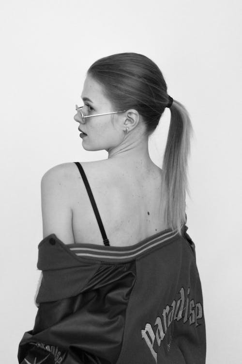 Young Woman in Sunglasses Posing in Studio