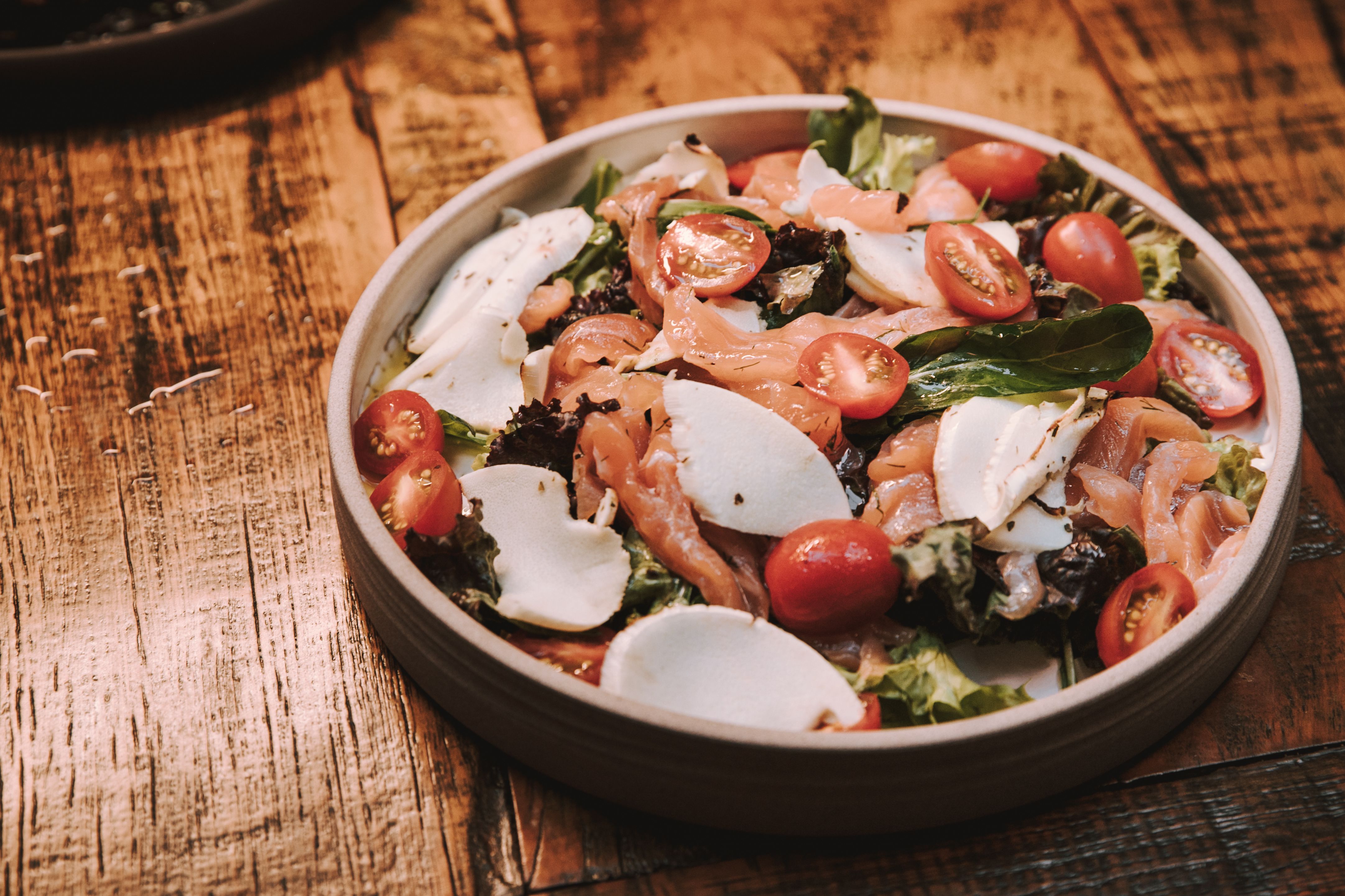 Smoked vegetable salad served in a bowl with fresh herbs
