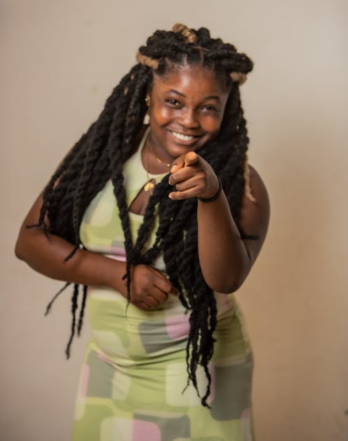 Portrait of a Woman Wearing Long Dreadlocks Pointing at the Camera