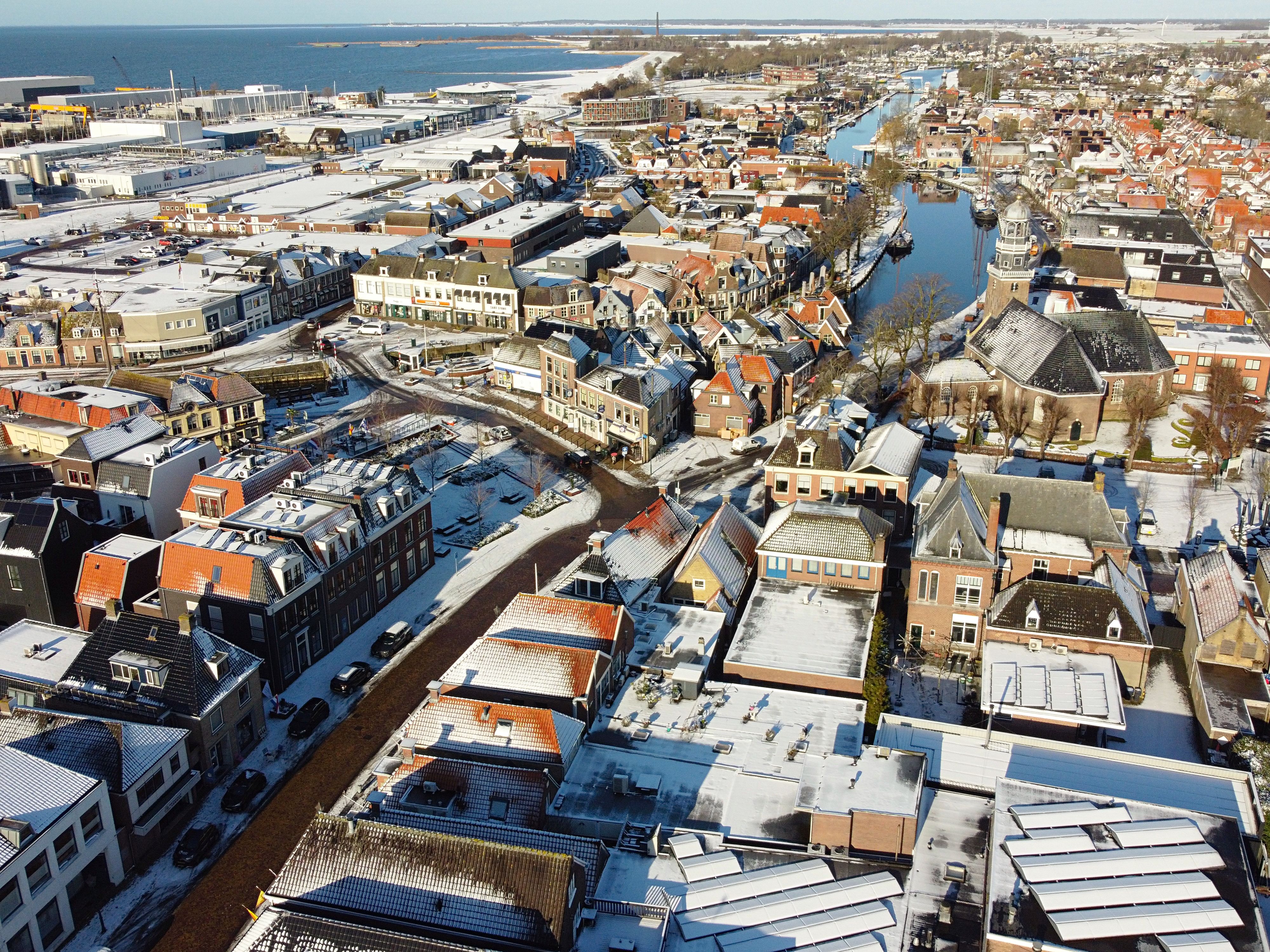 Aerial Footage of a Winter Town Roofs in Snow · Free Stock Photo