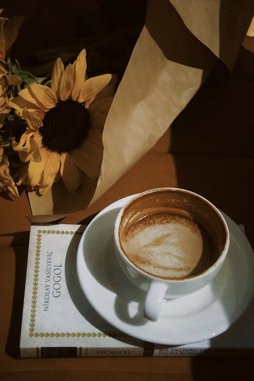 A Cup of Coffee, a Book and a Bouquet of a Table 