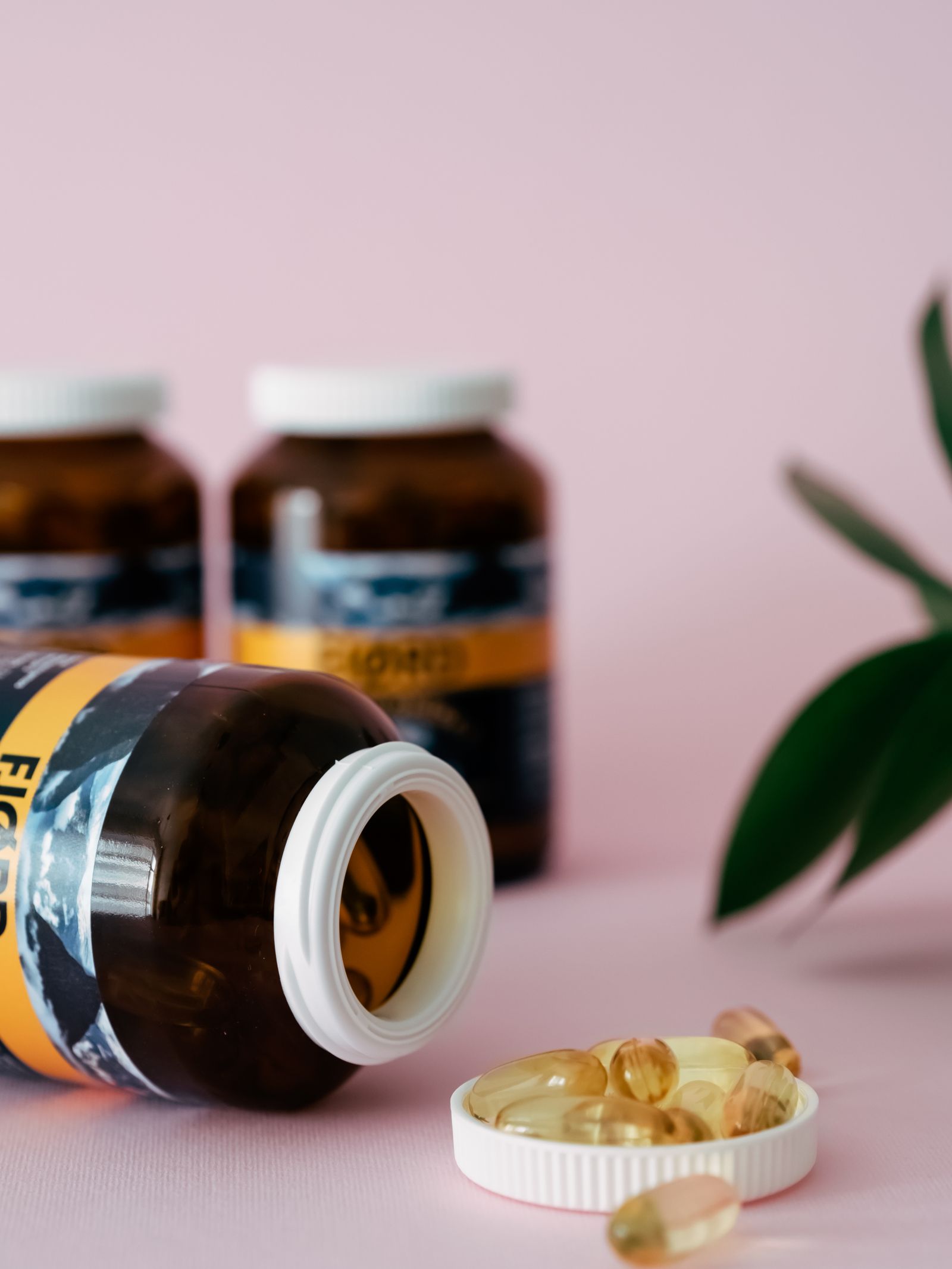 Supplement bottles and capsules arranged on a clean wellness surface.