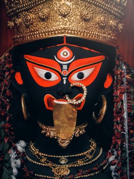 A close-up of Goddess Kali idol with vivid colors, symbolic of Hindu spiritual traditions in Kolkata, India.