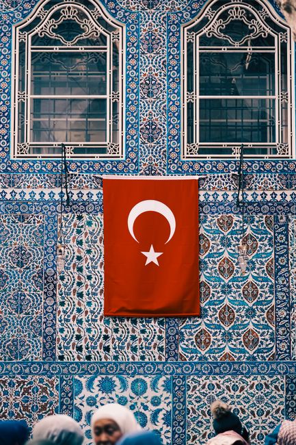 Turkish flag on a traditional mosaic facade in Istanbul, showcasing rich cultural heritage.