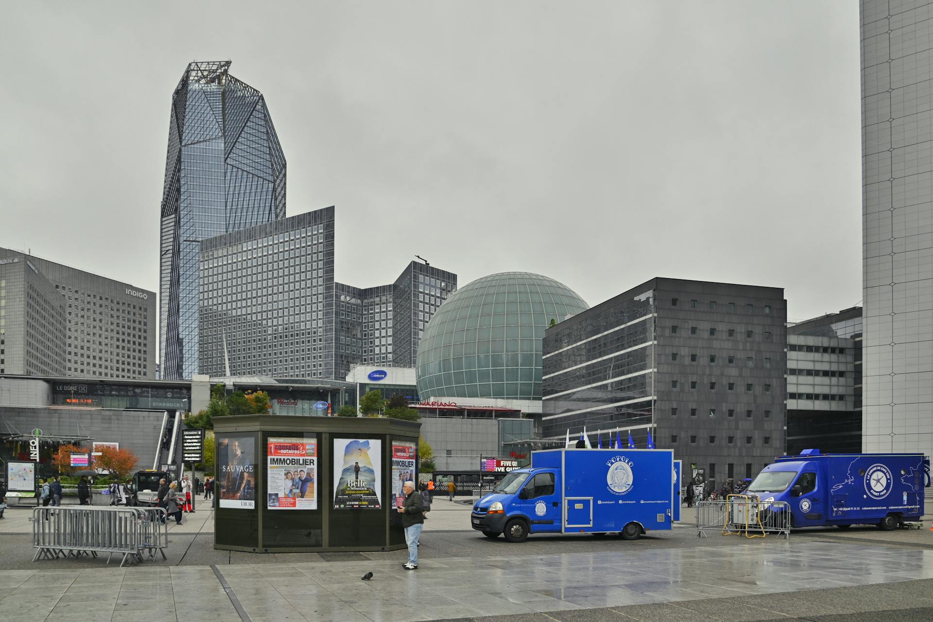 PARIS, FRANCE - October, 15, 2022 Defence Arch esplanade (La Defense) with view over modern office business steel and glass buildings and square in front of the arch with Popolo Street P...