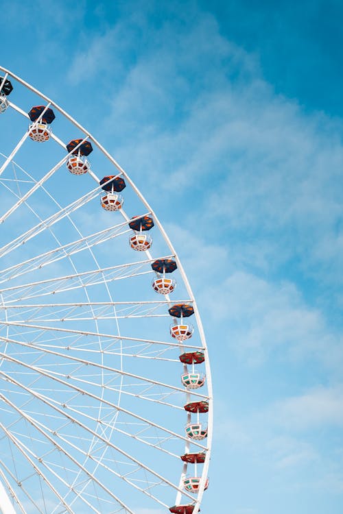 Ferris Wheel against White Clouds
