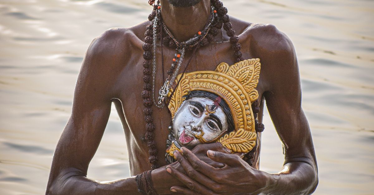 Man Holding Kali Mask and Taking Ritual Bath in Ganges River · Free ...