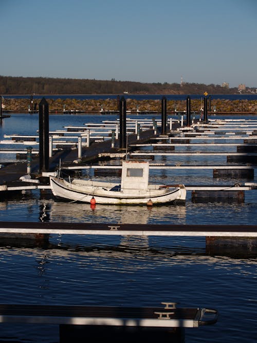 Free Fishing Boat Moored in an Empty Marina Stock Photo